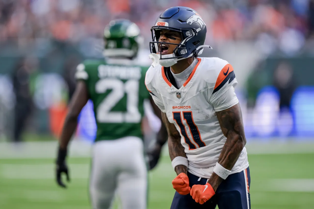 Denver Broncos wide receiver Troy Franklin (R) reacts