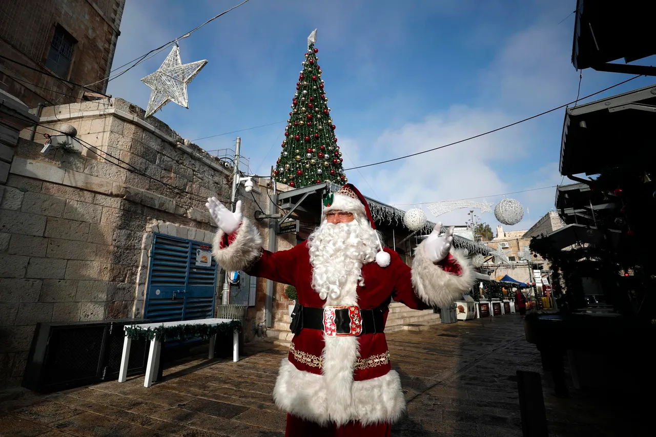 Issa Kassissieh, dressed as Santa Claus, greets people in Jerusalem&#8217;s old city