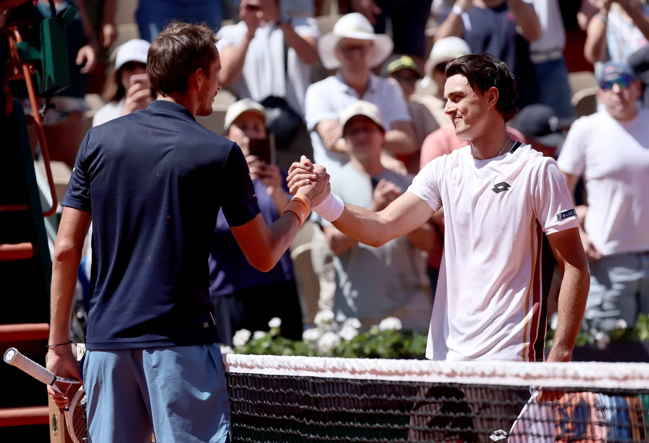 Adam Walton (R) of Australia is congratulated at the net by Daniil Medvedev of Russia after he won their Men's 1st round match at the French Open Grand Slam