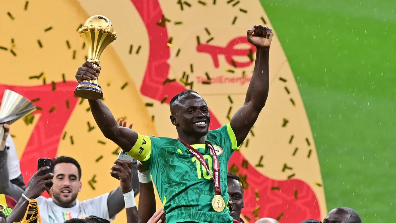 Sadio Mane of Senegal celebrates holding the trophy after winning the CAF Africa Cup of Nations after the final match between Senegal