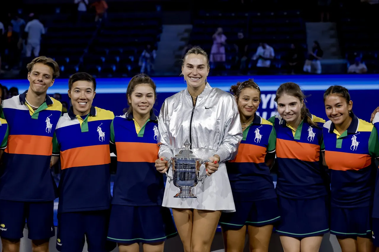 Aryna Sabalenka (C), of Belarus poses with the ball