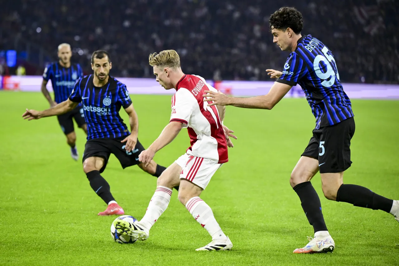 Henrikh Mkhitaryan (L) of Internazionale, Oliver Edvardsen (C) of Ajax and Alessandro Bastoni of Inter