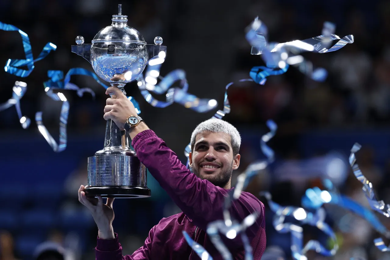 Carlos Alcaraz of Spain poses with his trophy after winning the final match against Taylor