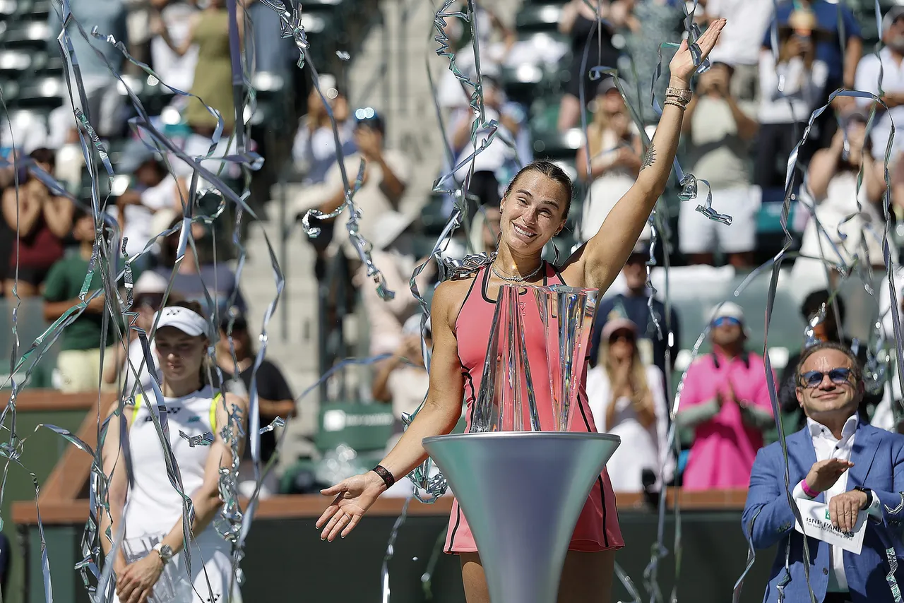 Aryna Sabalenka of Belarus poses with her Champions trophy as streamers fall after winning