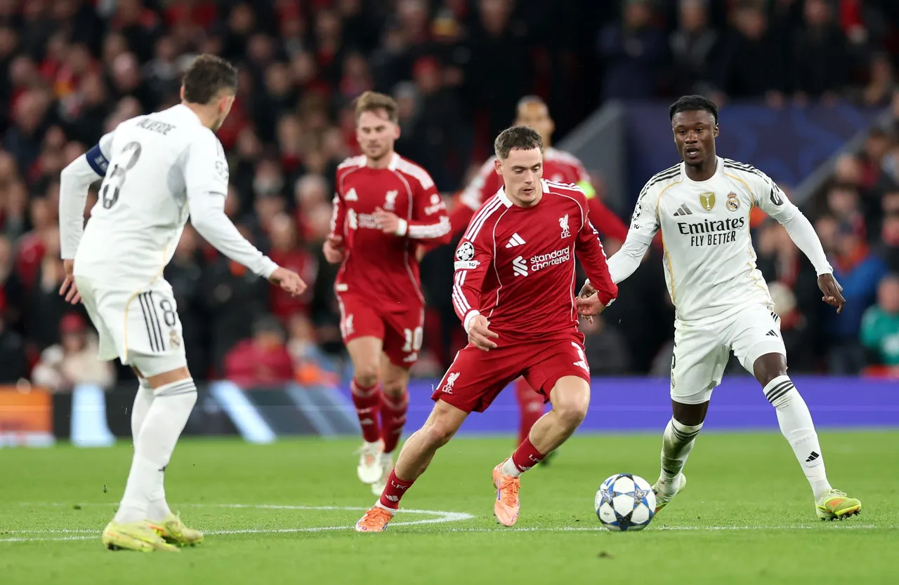 Liverpool in action against Federico Valverde (L) and Eduardo Camavinga of Real Madrid during the UEFA Champions League