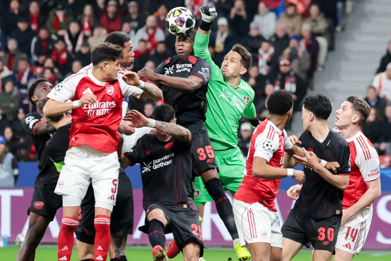 Goalkeeper Janis Blaswich of Bayer Leverkusen (C-R) makes a save during the UEFA Champions League