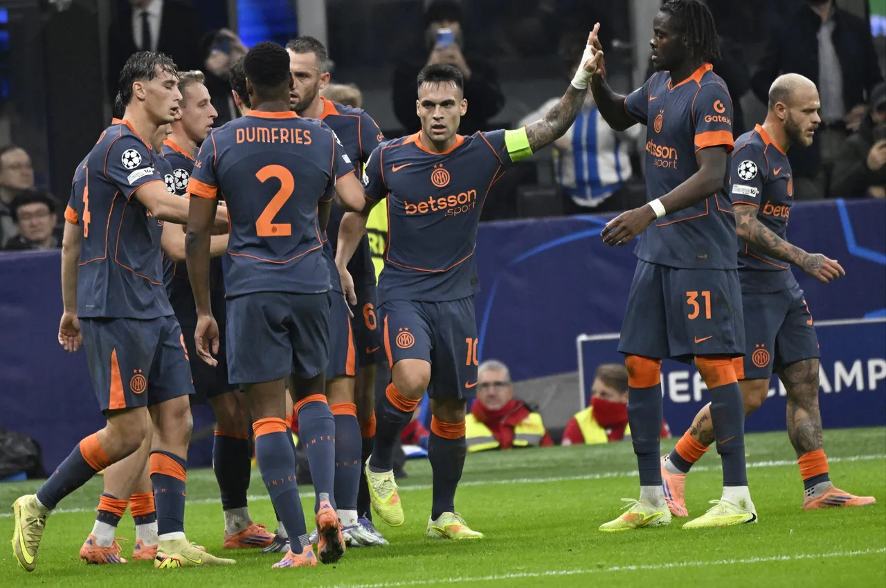 Inter Milan’s Lautaro Martinez (C) celebrates with teammates after scoring the 1-0