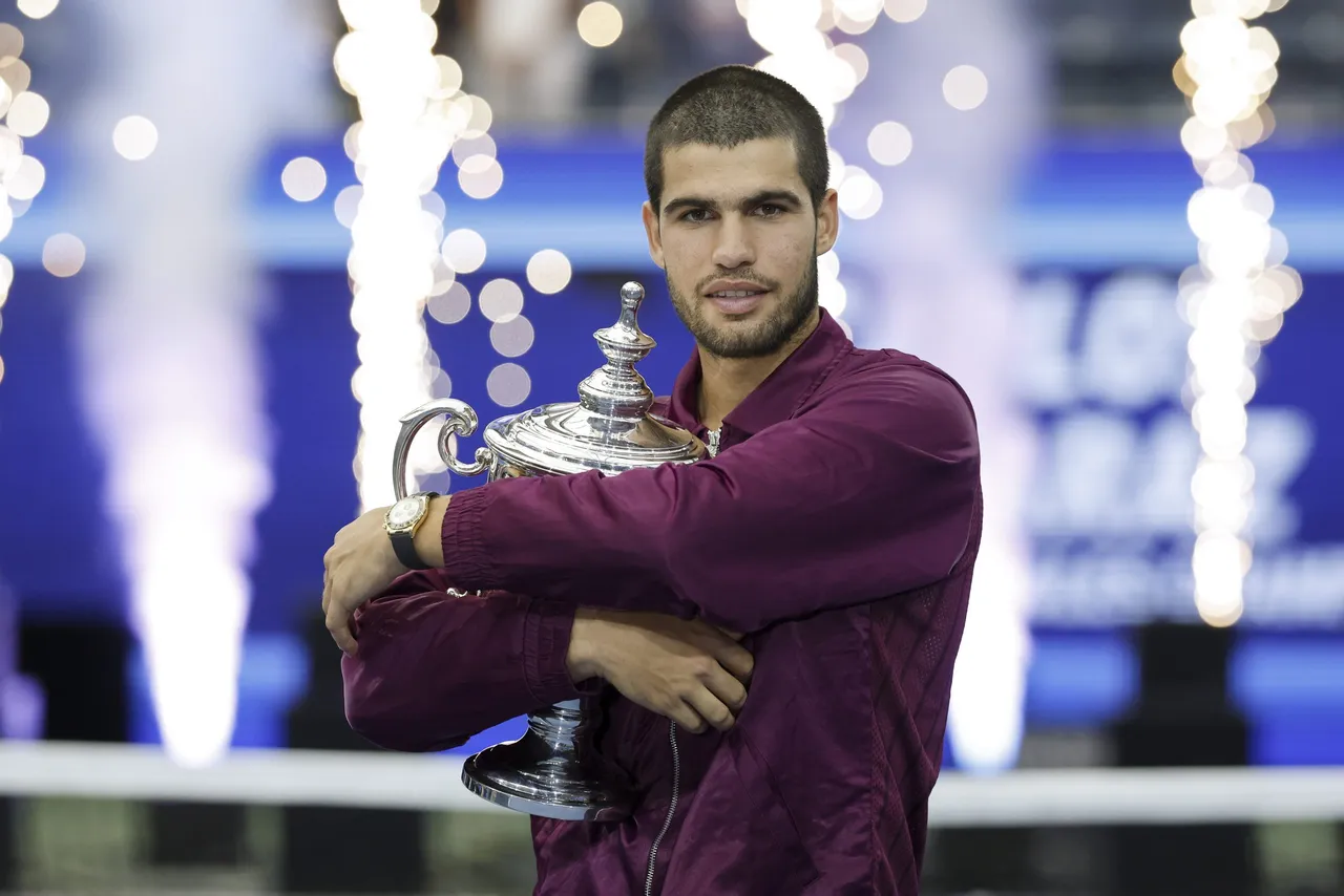 Carlos Alcaraz of Spain poses with the Champions trophy