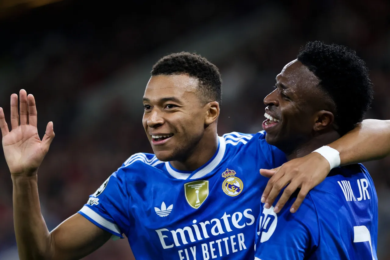 Real Madrid Kylian Mbappe (L) celebrates after scoring a goal during the UEFA Champions League
