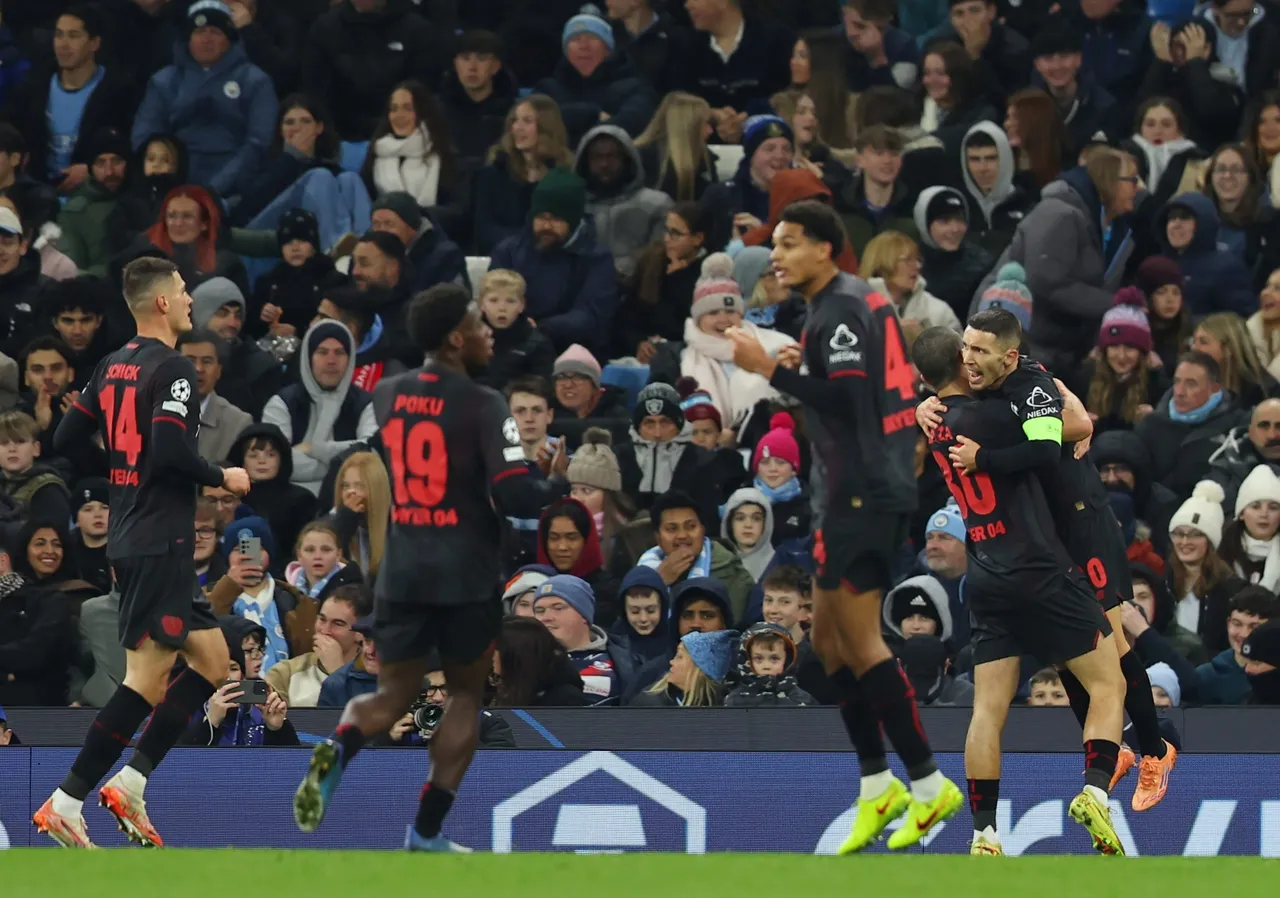 Leverkusen Alejandro Grimaldo (R) celebrates with teammates after s