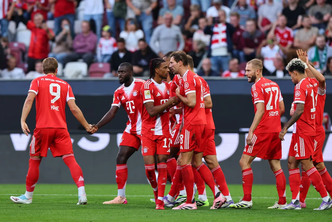 Michael Olise of Bayern Munich (C) celebrates with teammates after scoring the 0-3 goal during the German Bundesliga