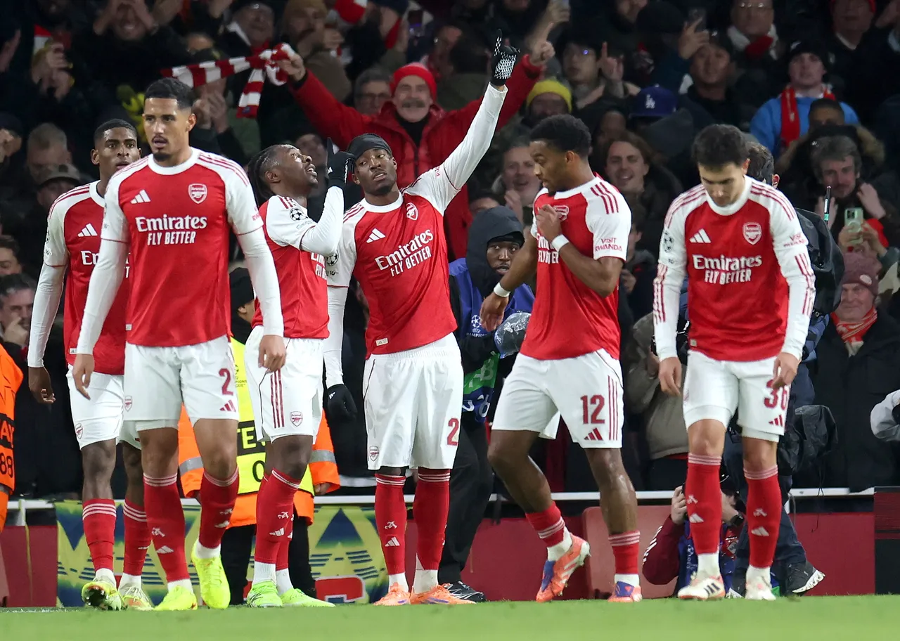 Arsenal celebrates with teammates after scoring his team's second goal during the UEFA Champions League