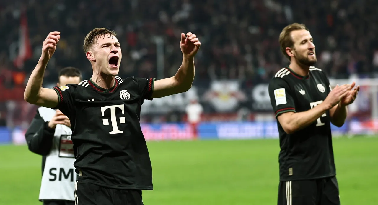 Harry Kane (R) and Joshua Kimmich of Bayern Munich greet their supporters after winning the German Bundesliga