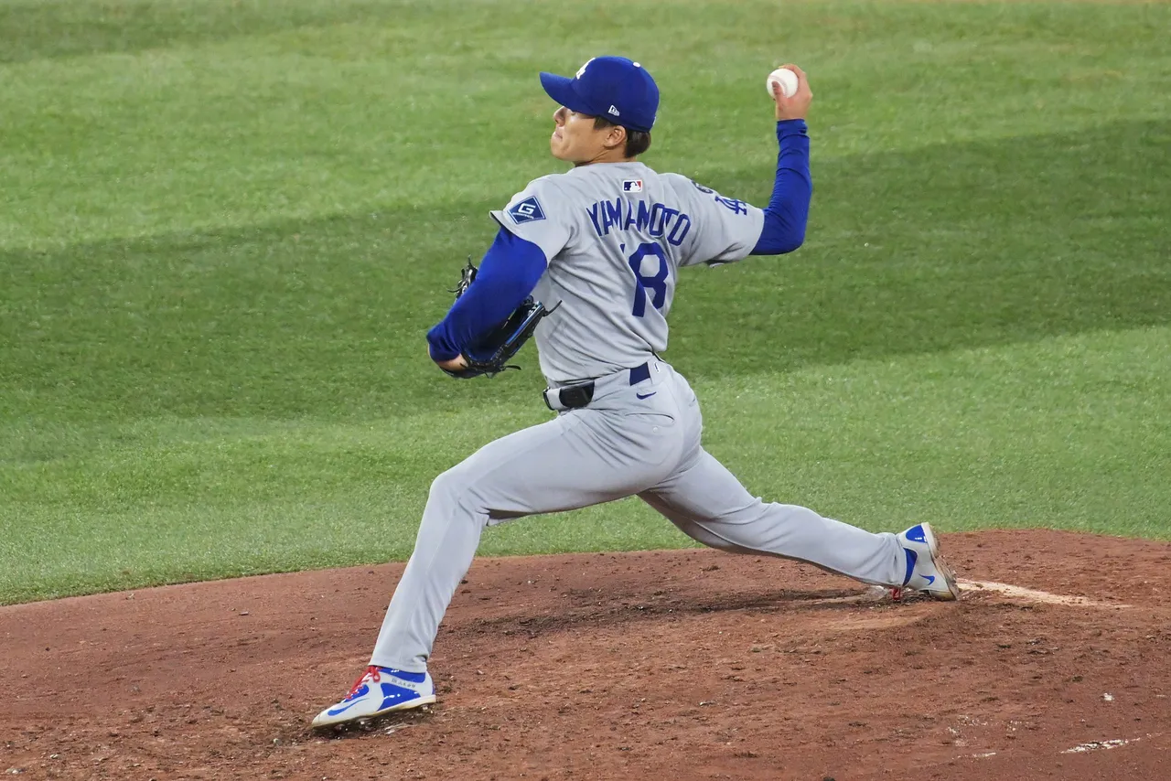 Los Angeles Dodgers pitcher Yoshinobu Yamamoto winds up for a pitch against