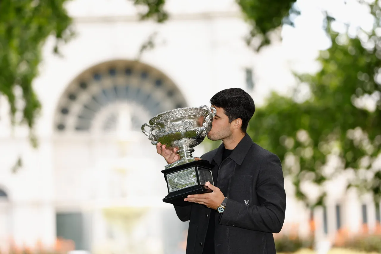 Carlos Alcaraz poses for a photograph after winning the AO 2026 men’s singles final against Novak Djokovic