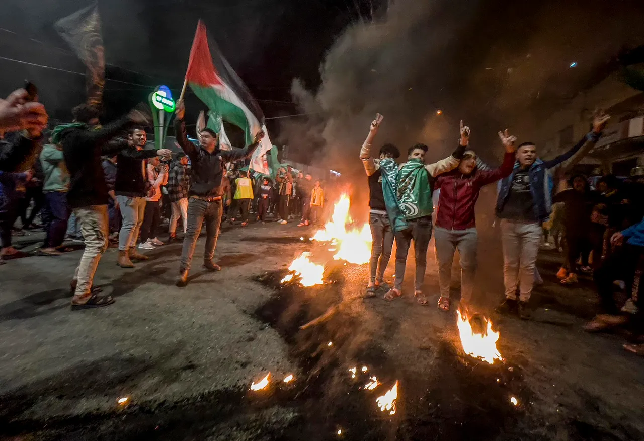 Palestinians celebrate after a shooting attack near a synagogue