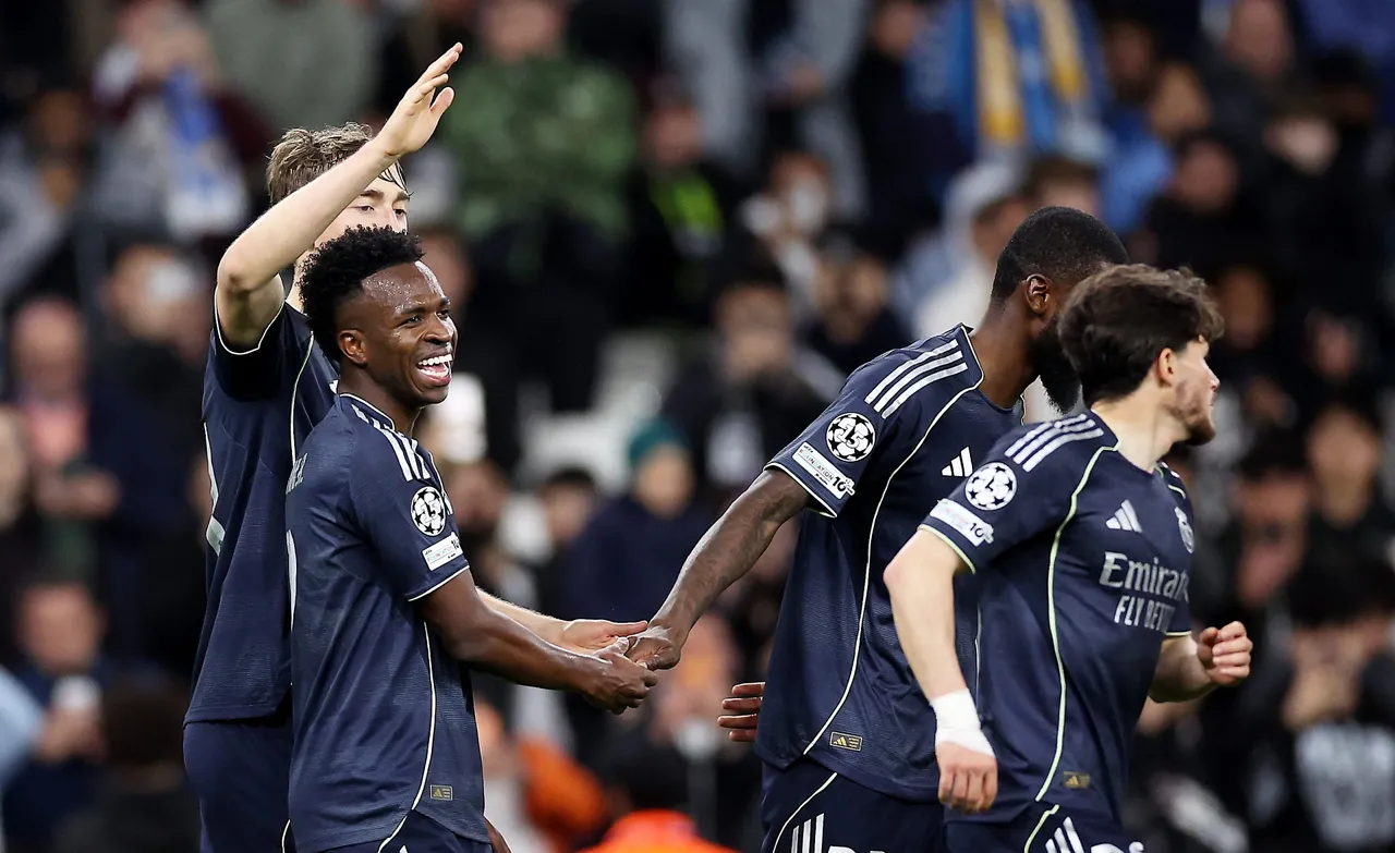 Vinicius Junior (L) of Real Madrid celebrates with teammates after scoring his second goal during the UEFA