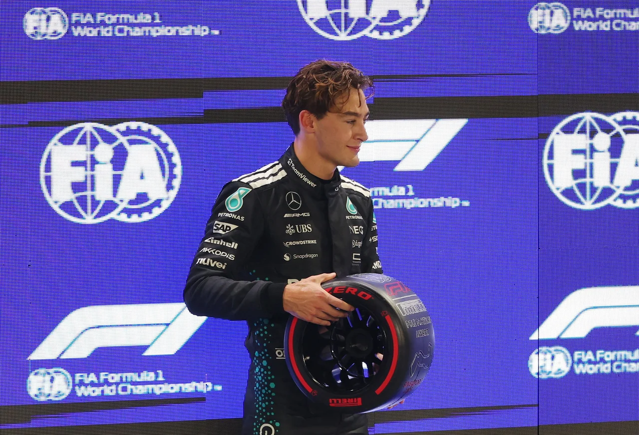Mercedes driver George Russell of Britain poses with his Pirelli Pole Position