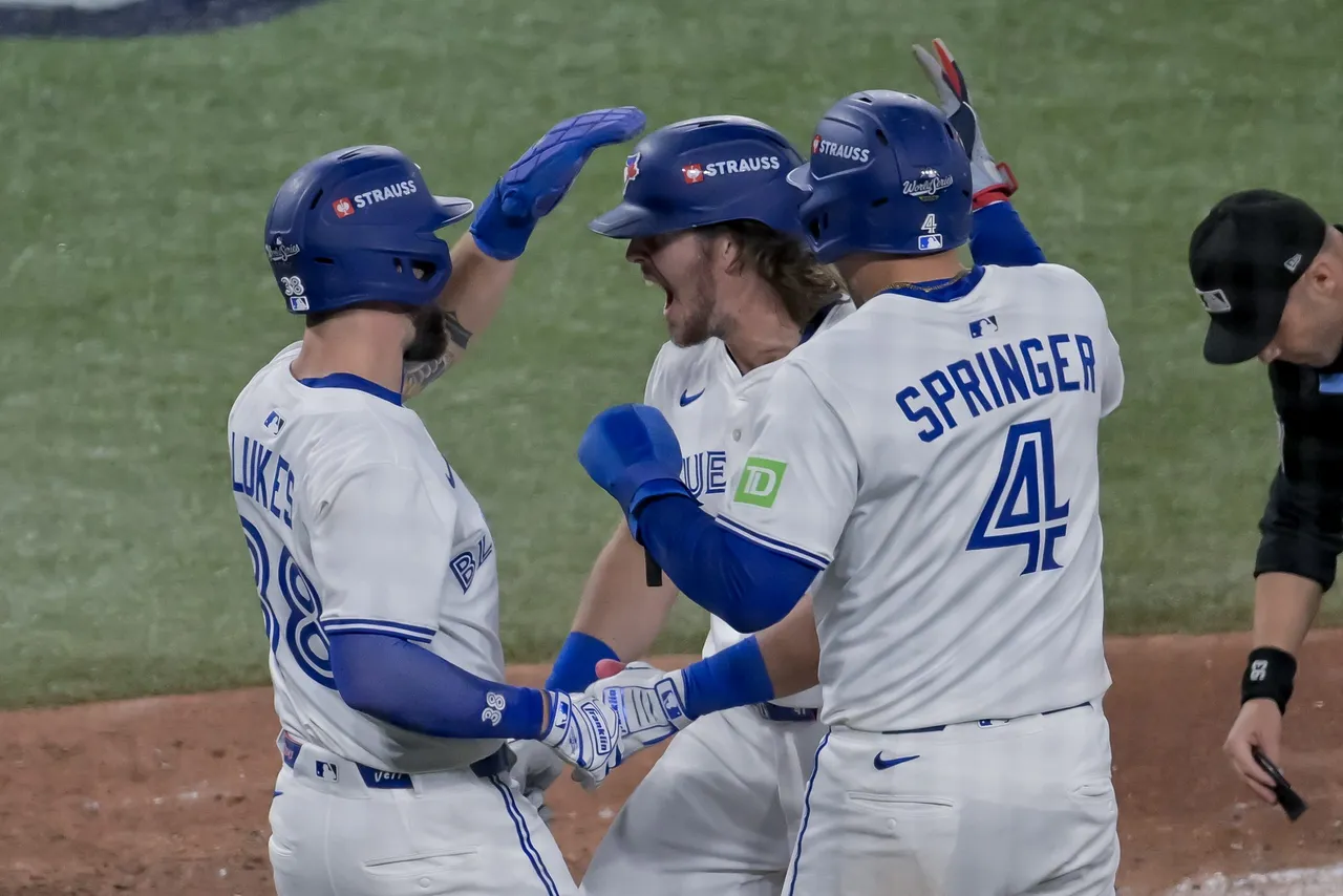 Toronto Blue Jays pinch hitter Addison Barger (C) celebrates with Nathan Lukes