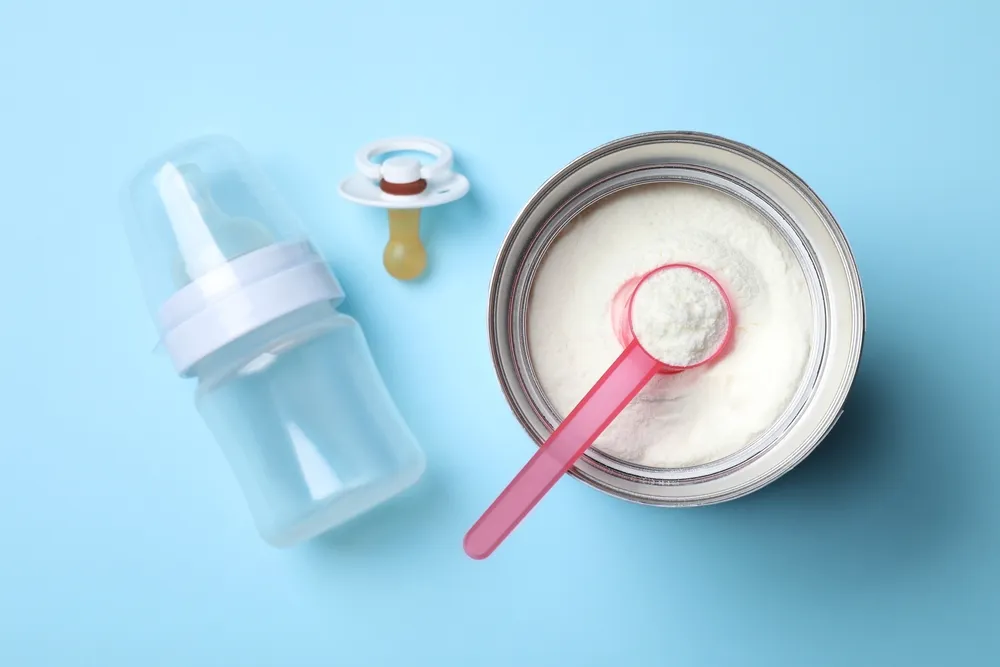 Flat,Lay,Composition,With,Powdered,Infant,Formula,On,Light,Blue