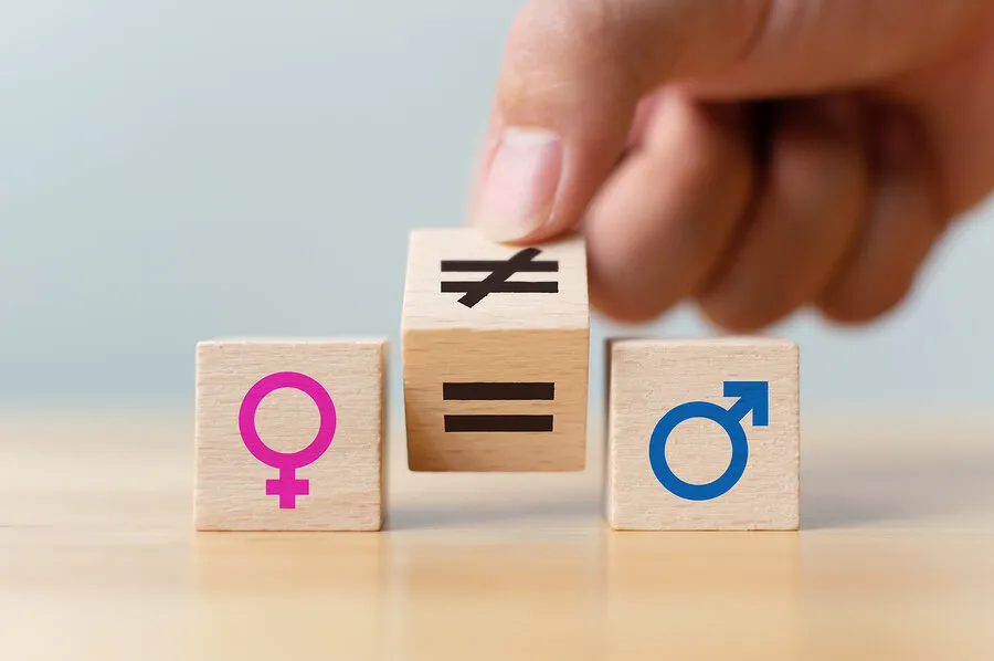 Concepts Of Gender Equality. Hand Flip Wooden Cube With Symbol U